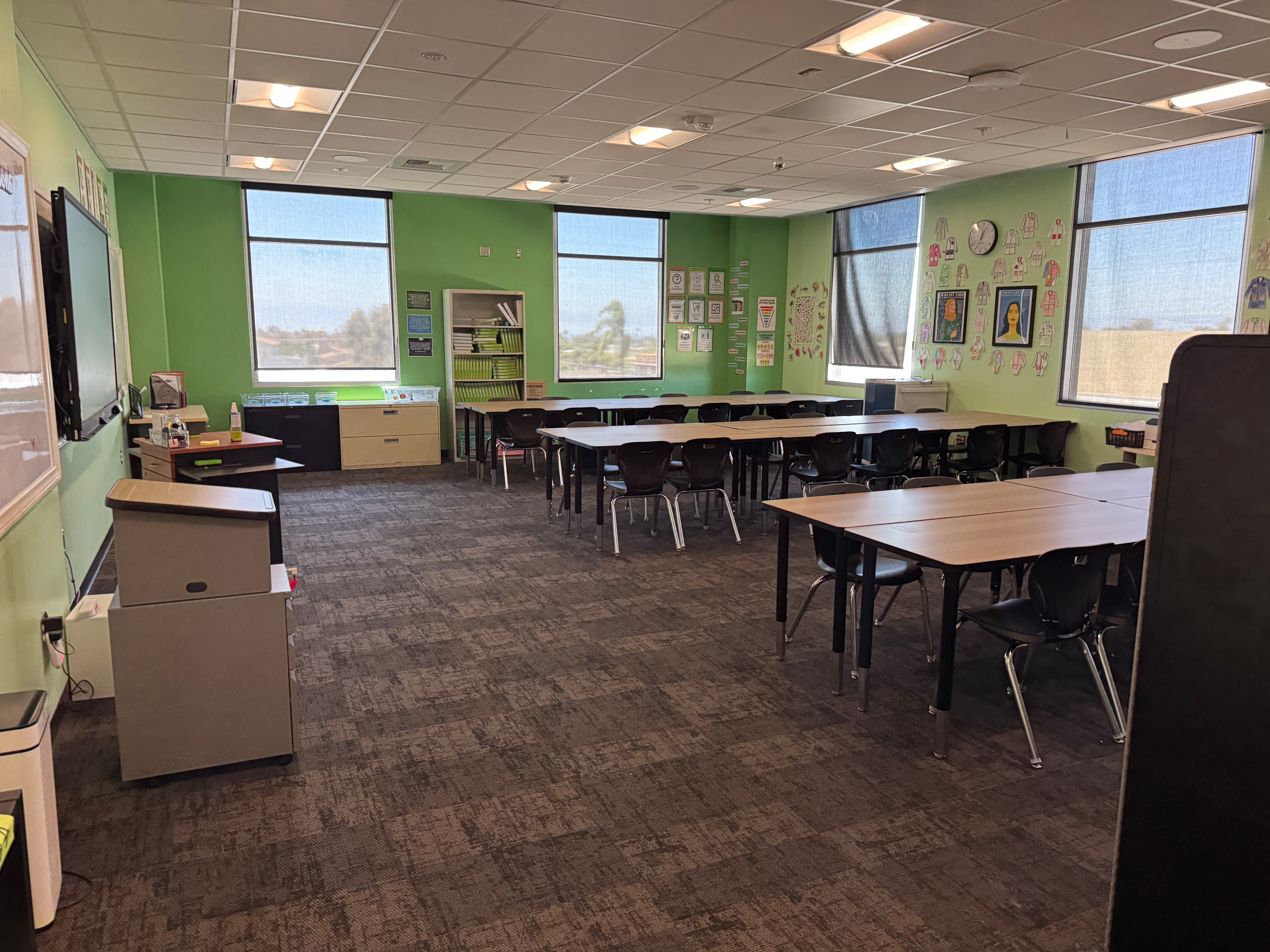 Completed classroom furniture installation with green walls