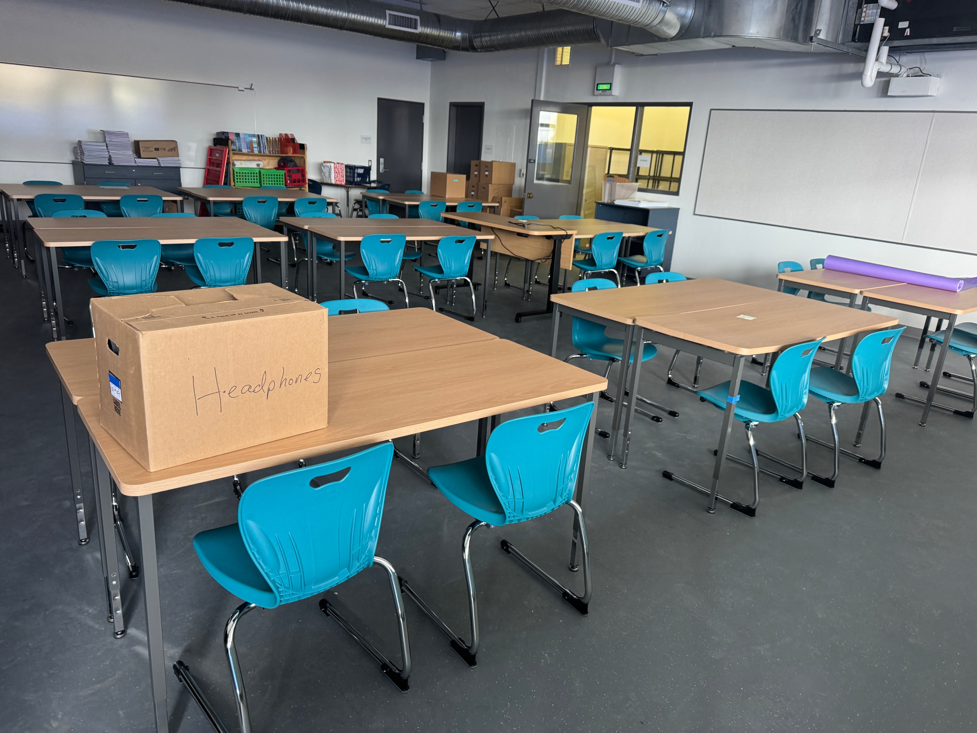 Classroom desks and teal chairs installation