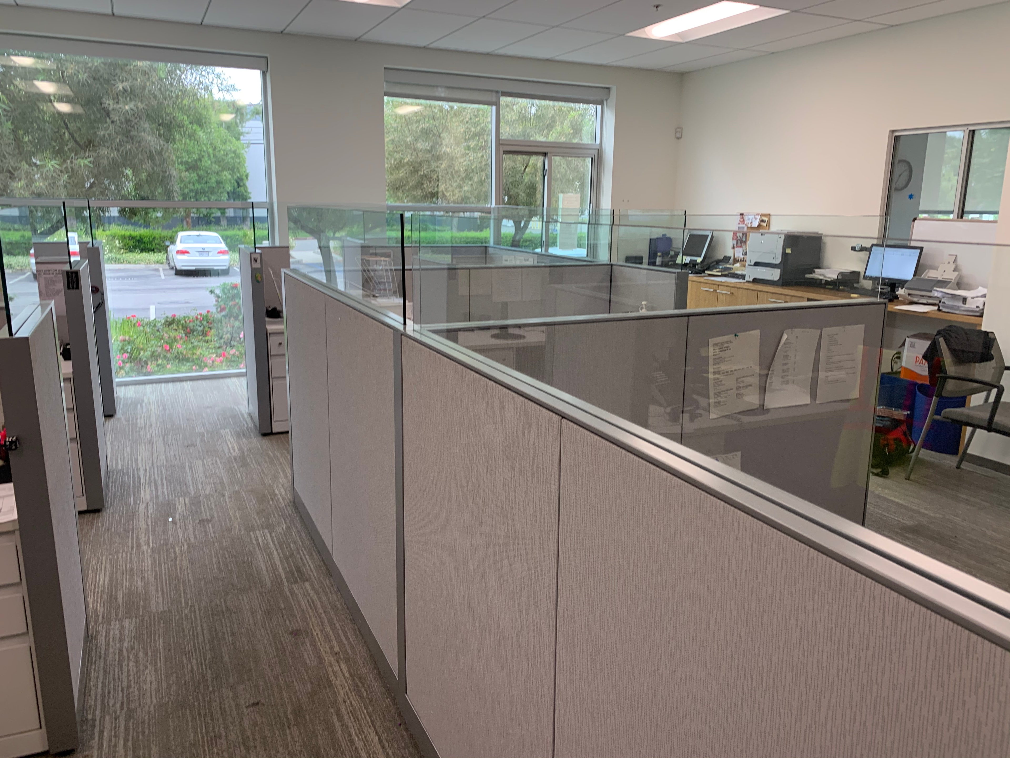 Office workstation installation with glass partition panels